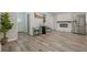 Open concept living room with hardwood floors, fireplace, and stainless steel refrigerator at 3349 Old Atlanta Rd, Suwanee, GA 30024