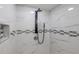 This shower has a black shower head and mosaic tiles and a soap nook at 3349 Old Atlanta Rd, Suwanee, GA 30024