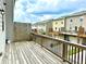 Wide angle view of wooden deck, privacy fence and row of Townhouses in backyard at 3658 Hidden Valley Cir, Lawrenceville, GA 30044