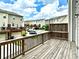 View of backyard featuring wooden deck, privacy fence and row of Townhouses at 3658 Hidden Valley Cir, Lawrenceville, GA 30044