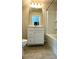 This bathroom has a toilet, vanity and a bathtub with a shower at 3658 Hidden Valley Cir, Lawrenceville, GA 30044