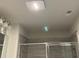 Modern bathroom with stylish light fixture, glass enclosed shower and grey tiling at 3658 Hidden Valley Cir, Lawrenceville, GA 30044