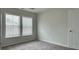 This bedroom features a window providing natural light and neutral carpeting at 3658 Hidden Valley Cir, Lawrenceville, GA 30044