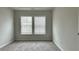 This bedroom features neutral walls, plush carpeting, and a large window at 3658 Hidden Valley Cir, Lawrenceville, GA 30044
