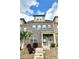 Charming brick townhome with a covered front porch and well-manicured landscaping, and concrete stairs at 3658 Hidden Valley Cir, Lawrenceville, GA 30044