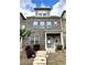 Charming brick townhome with a covered front porch and well-manicured landscaping, and concrete stairs at 3658 Hidden Valley Cir, Lawrenceville, GA 30044