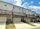Townhome garages and decks on a sunny day showcasing outdoor living at 3658 Hidden Valley Cir, Lawrenceville, GA 30044