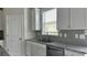 Modern kitchen features granite countertops, stainless steel appliances, and white cabinets at 3658 Hidden Valley Cir, Lawrenceville, GA 30044