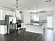Spacious kitchen with granite countertops, stainless steel appliances, island, and grey backsplash at 3658 Hidden Valley Cir, Lawrenceville, GA 30044