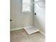 Tile-floored laundry room with window offers natural light and a functional space at 3658 Hidden Valley Cir, Lawrenceville, GA 30044