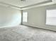 Spacious carpeted main bedroom featuring two bright windows and a tray ceiling at 3658 Hidden Valley Cir, Lawrenceville, GA 30044