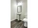 Cozy powder room with modern pedestal sink and fixtures offers a fresh design at 3658 Hidden Valley Cir, Lawrenceville, GA 30044