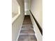 Carpeted stairway with stained handrail is ready to lead you to the next level of your home at 3658 Hidden Valley Cir, Lawrenceville, GA 30044