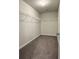 Walk-in closet features built-in shelving and neutral carpet at 3658 Hidden Valley Cir, Lawrenceville, GA 30044
