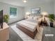 Serene bedroom with a cozy bed, soft lighting, and a picturesque window view, creating a relaxing retreat at 6735 Smoke Ridge Dr, Atlanta, GA 30349