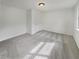 Standard bedroom with neutral carpet, a ceiling light, and window at 6735 Smoke Ridge Dr, Atlanta, GA 30349