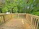 Exterior view of the wooden deck, surrounded by lush trees at 6735 Smoke Ridge Dr, Atlanta, GA 30349