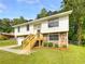 Charming two-story home featuring stone accents, a well-manicured lawn, and a welcoming front porch, creating great curb appeal at 6735 Smoke Ridge Dr, Atlanta, GA 30349