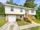 Well-maintained two-story home with stone accents, a manicured lawn, and a welcoming front porch that adds to its curb appeal at 6735 Smoke Ridge Dr, Atlanta, GA 30349