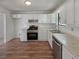 Updated kitchen featuring stainless steel appliances, white cabinets, and modern fixtures, providing a functional cooking space at 6735 Smoke Ridge Dr, Atlanta, GA 30349