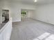 Spacious living room with new carpet and access to a deck at 6735 Smoke Ridge Dr, Atlanta, GA 30349