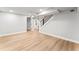 Finished basement with open floor plan, light wood floors, recessed lighting, and wooden stairs at 2128 Hosea L Williams Ne Dr, Atlanta, GA 30317