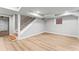 Finished basement features light gray walls, light wood floors, wooden stairs, and natural light at 2128 Hosea L Williams Ne Dr, Atlanta, GA 30317