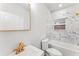 Bright bathroom featuring a white vanity, gold fixtures, and marble tile backsplash at 2128 Hosea L Williams Ne Dr, Atlanta, GA 30317