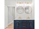 Bathroom with double sink vanity, unique mirrors and lighting, and modern fixtures at 2128 Hosea L Williams Ne Dr, Atlanta, GA 30317