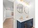 Bathroom with double vanity, framed mirrors, vanity lighting, and an open doorway to the bedroom at 2128 Hosea L Williams Ne Dr, Atlanta, GA 30317
