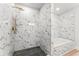Modern bathroom featuring a shower with marble-patterned walls and gold accents at 2128 Hosea L Williams Ne Dr, Atlanta, GA 30317