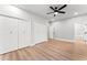Bedroom with hardwood floors, ceiling fan, and access to a bathroom with marble tile at 2128 Hosea L Williams Ne Dr, Atlanta, GA 30317