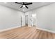 Neutral bedroom with hardwood floors and ceiling fan showcasing access to an ensuite bathroom at 2128 Hosea L Williams Ne Dr, Atlanta, GA 30317