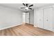 Bedroom featuring light gray walls, light wood floors, ceiling fan, and double door closet at 2128 Hosea L Williams Ne Dr, Atlanta, GA 30317