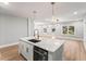Bright kitchen featuring a large island with a stainless steel dishwasher and a sink with a modern faucet at 2128 Hosea L Williams Ne Dr, Atlanta, GA 30317