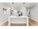 Updated kitchen with a large island, stone countertops and designer light fixtures at 2128 Hosea L Williams Ne Dr, Atlanta, GA 30317