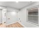 Bright laundry room features wood-look floors, white walls, utility hookups and a window allowing natural light at 2128 Hosea L Williams Ne Dr, Atlanta, GA 30317