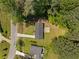 Aerial view of a home featuring a dark roof, a long driveway and mature trees at 2340 Cresta Dr, Decatur, GA 30032