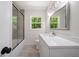 Contemporary bathroom with modern lighting, tub with shower, and Quartz countertop vanity at 2340 Cresta Dr, Decatur, GA 30032