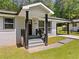 Inviting front entrance with a covered porch, black railings and freshly painted brick at 2340 Cresta Dr, Decatur, GA 30032
