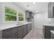 A modern kitchen featuring grey cabinets, white countertops, stainless steel appliances and wood look flooring at 2340 Cresta Dr, Decatur, GA 30032