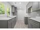 A modern kitchen features gray cabinets, white countertops, stainless appliances, and wood look flooring at 2340 Cresta Dr, Decatur, GA 30032