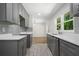 Modern kitchen featuring grey cabinets, white countertops, stainless steel appliances, and wood look flooring at 2340 Cresta Dr, Decatur, GA 30032
