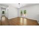 Open-plan living area with beautiful hardwood floors and double French doors to outdoor deck at 2340 Cresta Dr, Decatur, GA 30032