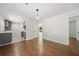 An open concept living room featuring hardwood floors and a view to the updated kitchen at 2340 Cresta Dr, Decatur, GA 30032