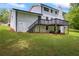 Spacious backyard featuring a deck, lush greenery, and mature trees providing shade at 3717 Birchbriar Ct, Decatur, GA 30034