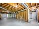 Unfinished basement area showing the stairs to the first floor, wood beams and duct work at 3717 Birchbriar Ct, Decatur, GA 30034