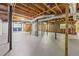 Unfinished basement with exposed duct work, wood beams, and freshly painted concrete floor at 3717 Birchbriar Ct, Decatur, GA 30034