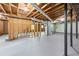 Spacious unfinished basement featuring exposed beams and painted concrete floor at 3717 Birchbriar Ct, Decatur, GA 30034