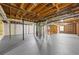 Unfinished basement featuring exposed wood beams and painted concrete flooring at 3717 Birchbriar Ct, Decatur, GA 30034